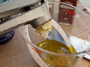 pushing-garlic-through-press