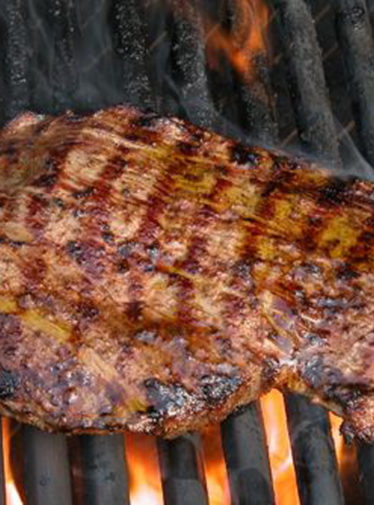 Flank steak on a grill.