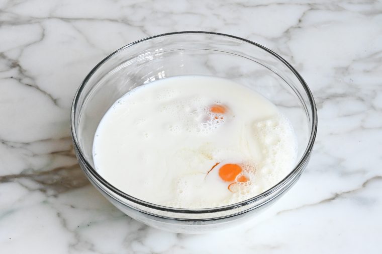 Eggs and milk in a bowl.