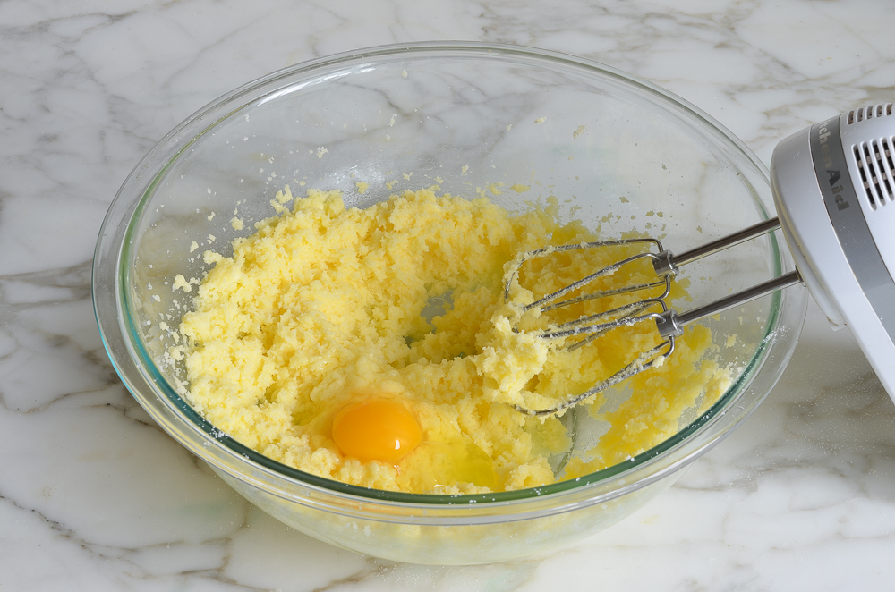 Egg added to a butter and sugar mixture.
