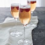 Tall stemmed glasses of kir royale.