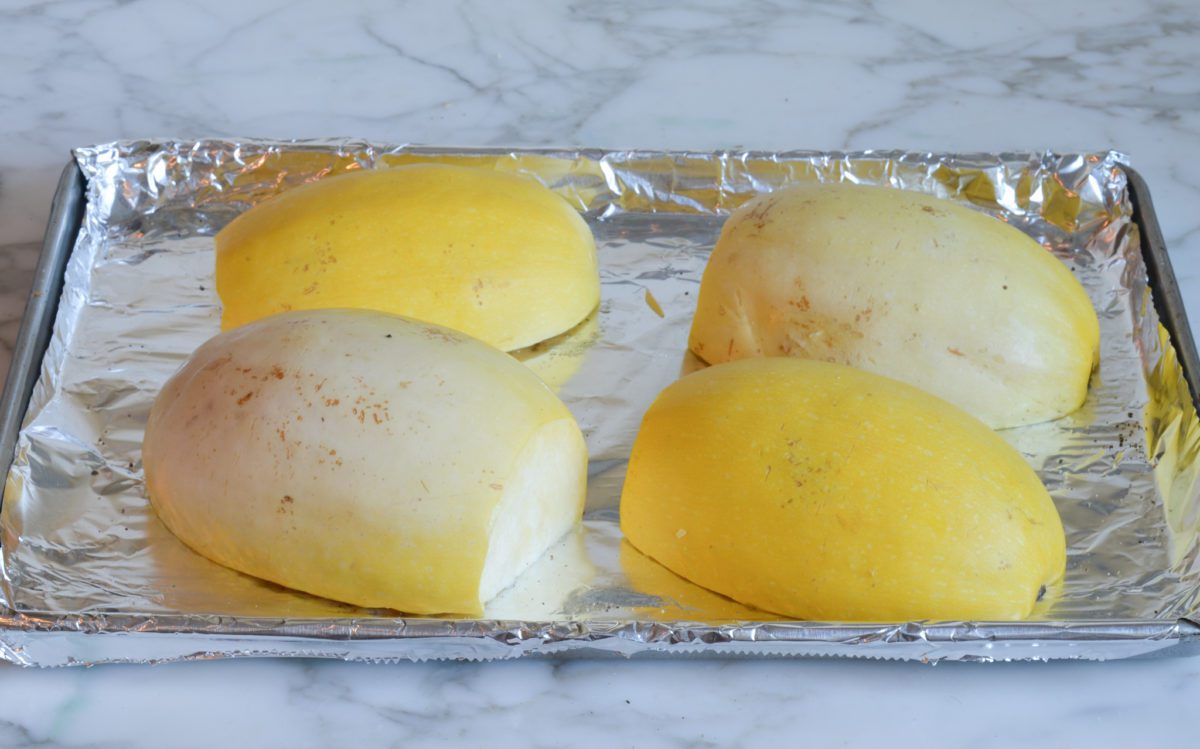 squash cut side down on baking sheet