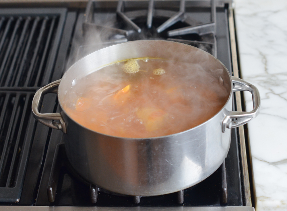 Sweet potatoes boiling on a stovetop.