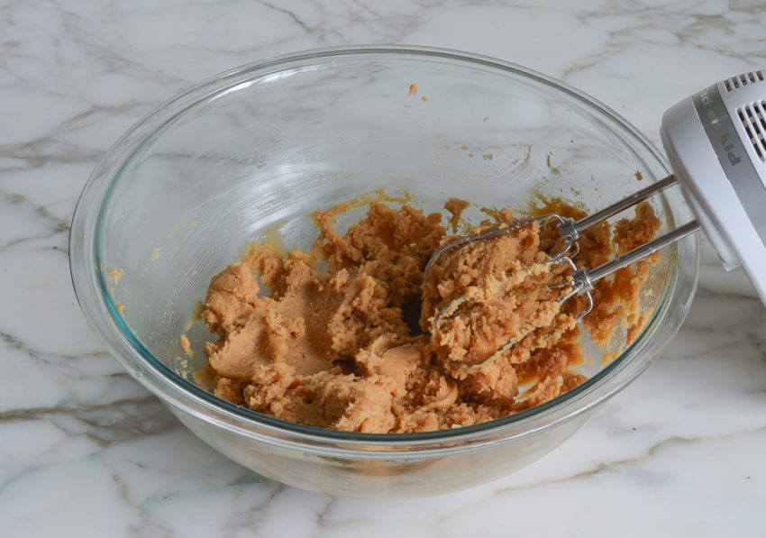 Electric mixer in a bowl with peanut butter filling.