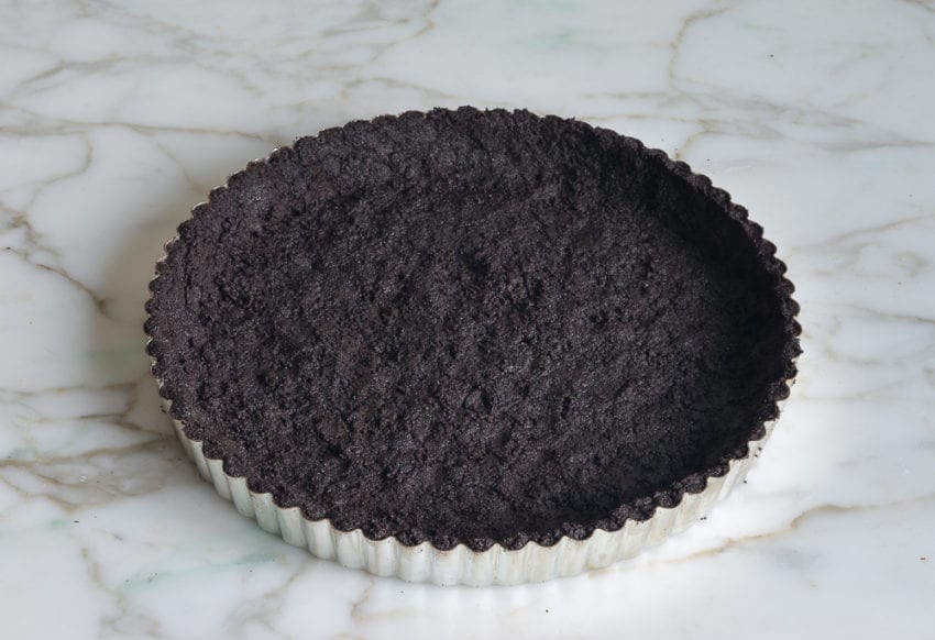 Tart pan with a chocolate crust.