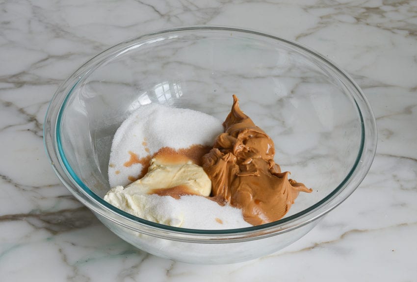 Bowl of unmixed peanut butter filling ingredients.