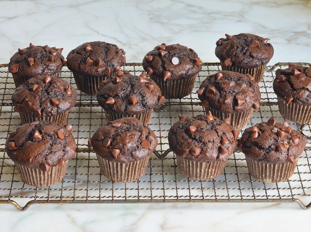 Chocolate muffins on a wire rack.