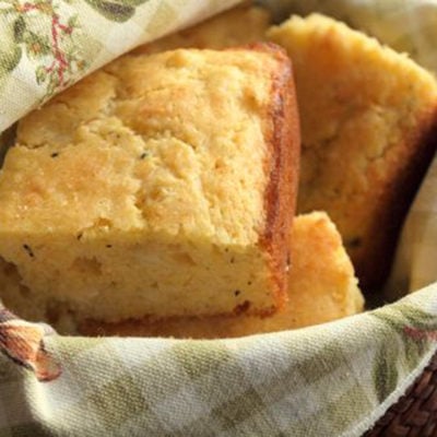 Pieces of savory cornbread with cheddar and thyme in a basket.