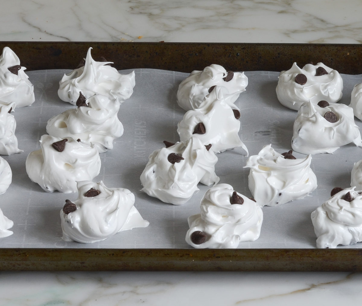 meringue mounds on baking sheet ready to bake
