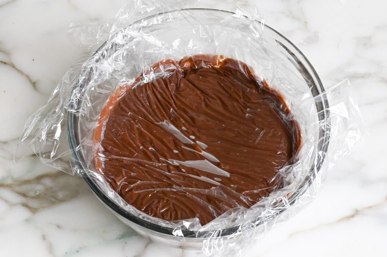 chocolate pudding in bowl covered with plastic wrap