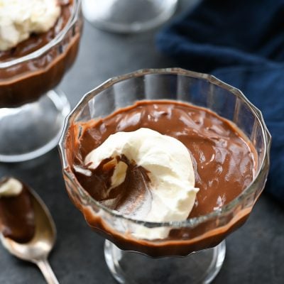 Glass of chocolate pudding missing a scoop.