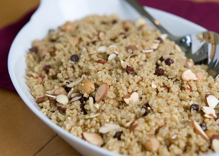 Bowl of quinoa pilaf with chickpeas, currants, and almonds.