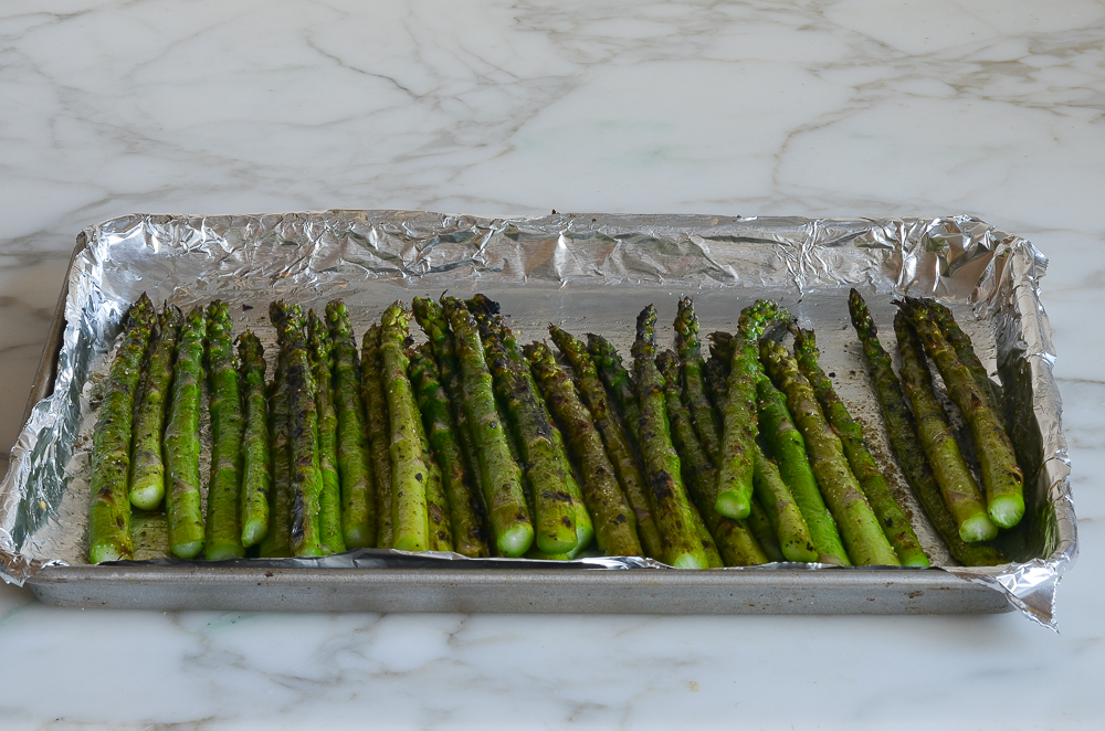 grilled asparagus on baking sheet