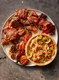 asian bbq chicken on platter with cucumber salad