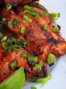 Asian-inspired barbeque chicken on a plate.