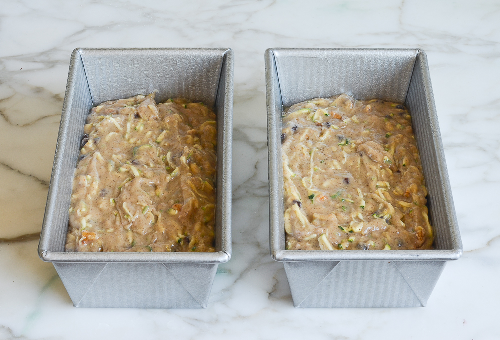 zucchini bread batter in greased baking pans