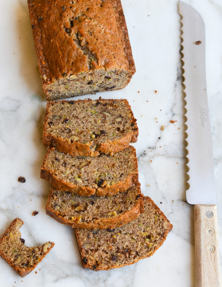 Partially-sliced loaf of zucchini bread.