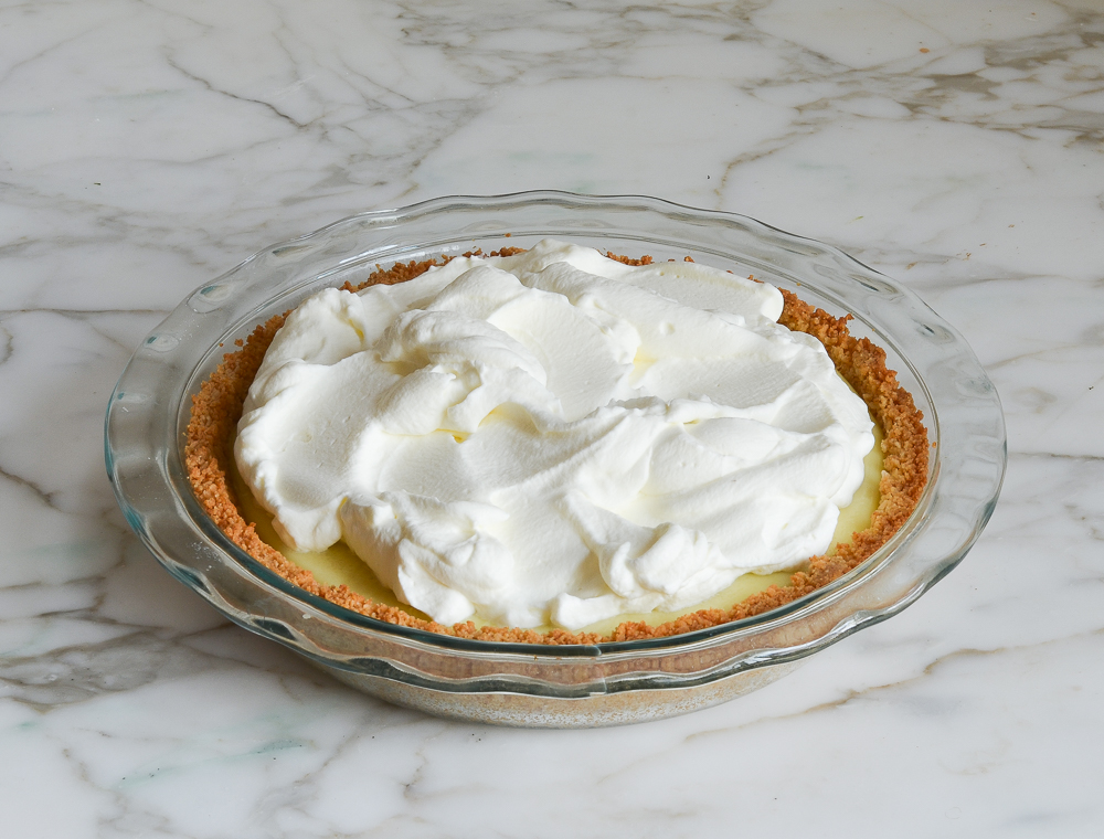 coconut cream pie topped with whipped cream