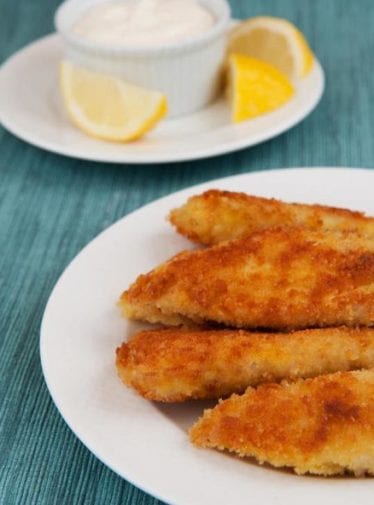 Plate of crispy tilapia fingers with lemon and garlic mayonnaise.