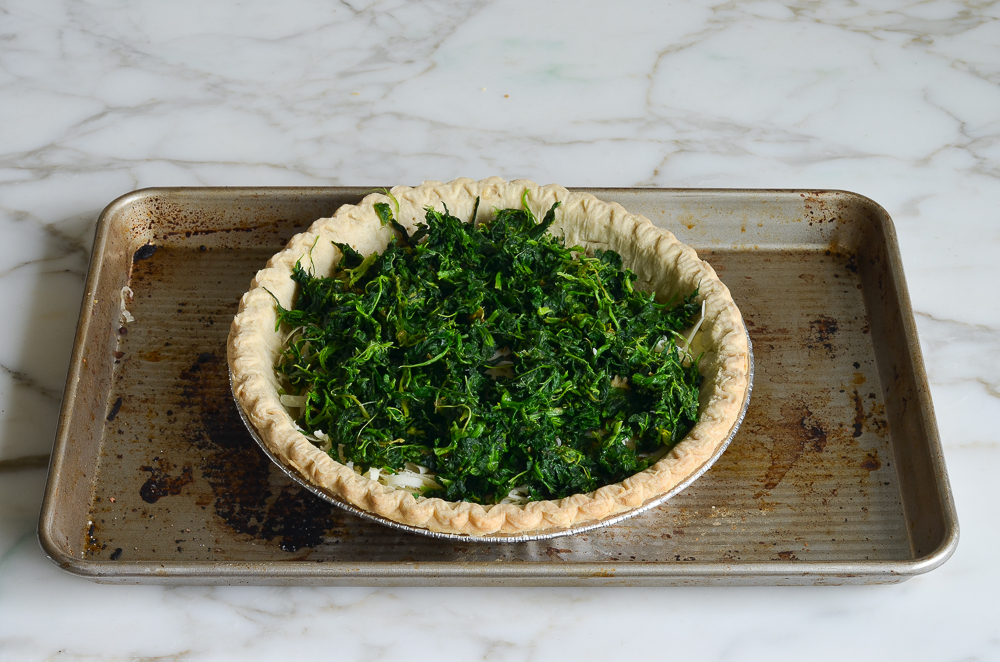 layering spinach in crust