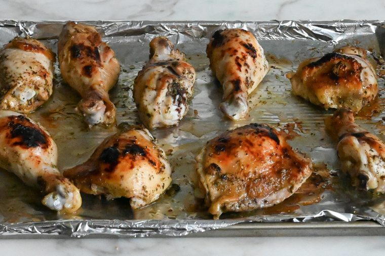 browned chicken on foil-lined baking sheet