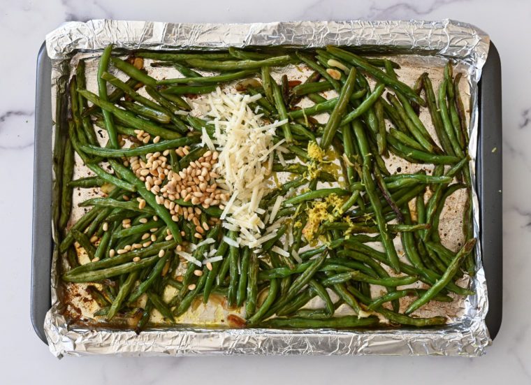 adding lemon zest, cheese, and pine nuts to the roasted green beans