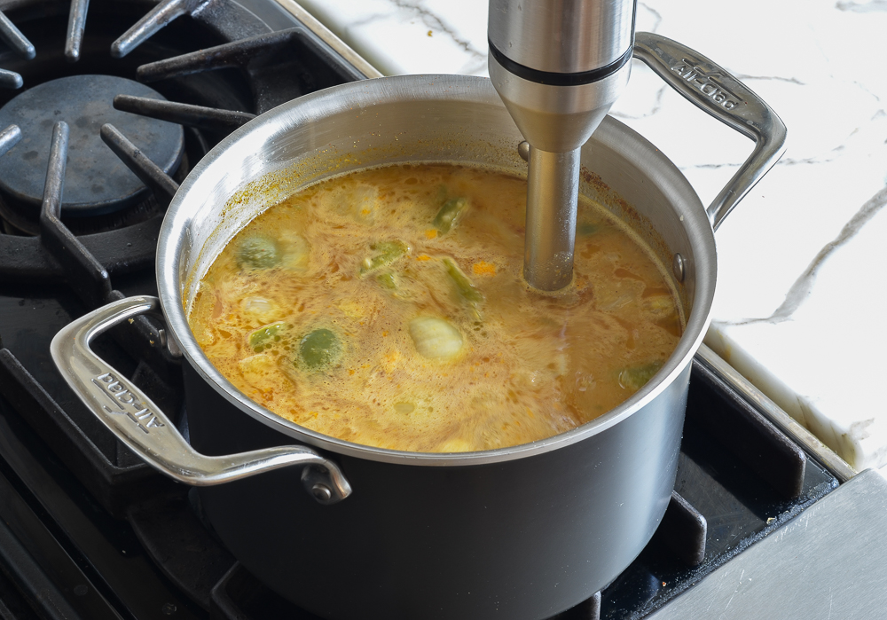 Immersion blender in a pot of soup.