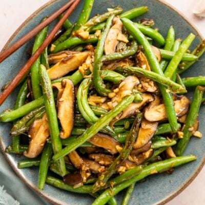 Szechuan green beans in bowl with chopsticks.