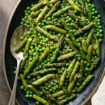 Sautéed asparagus and peas on serving platter.