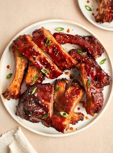 baby back ribs with hoisin bbq sauce on white plate.