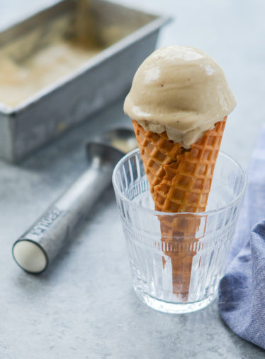 Caramelized banana ice cream cone in a glass.