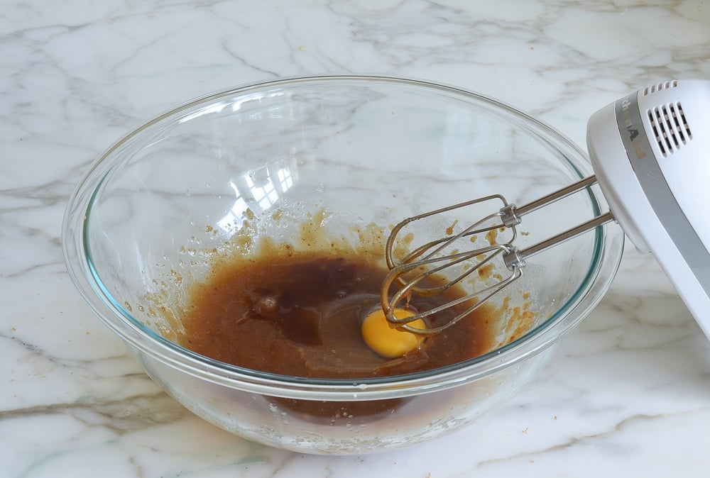 An egg and the vanilla added to the bowl with the sugar and butter.