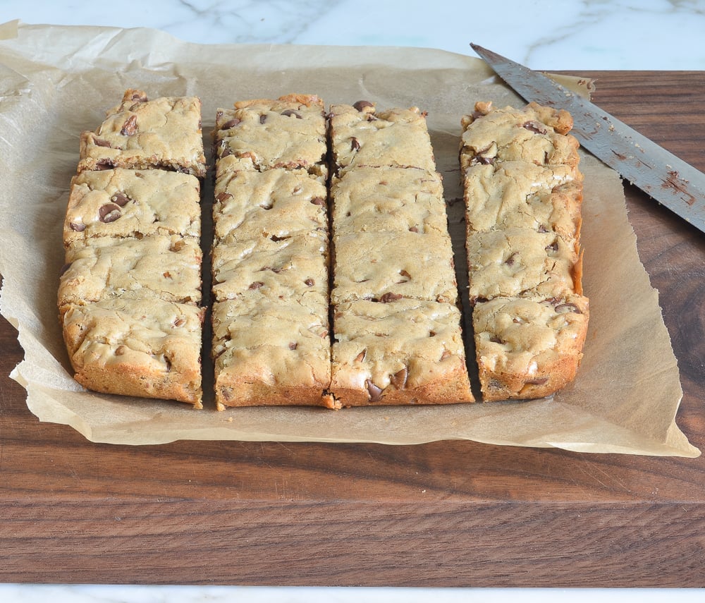 Blondies on a piece of parchment paper cut into squares.