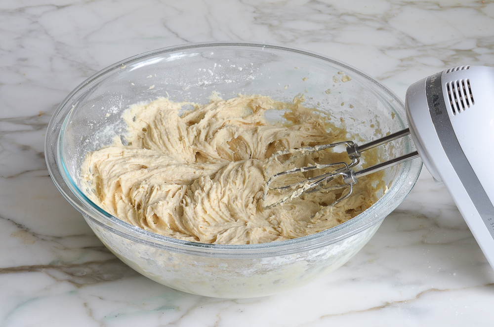 Bowl of muffin batter with an electric mixer.