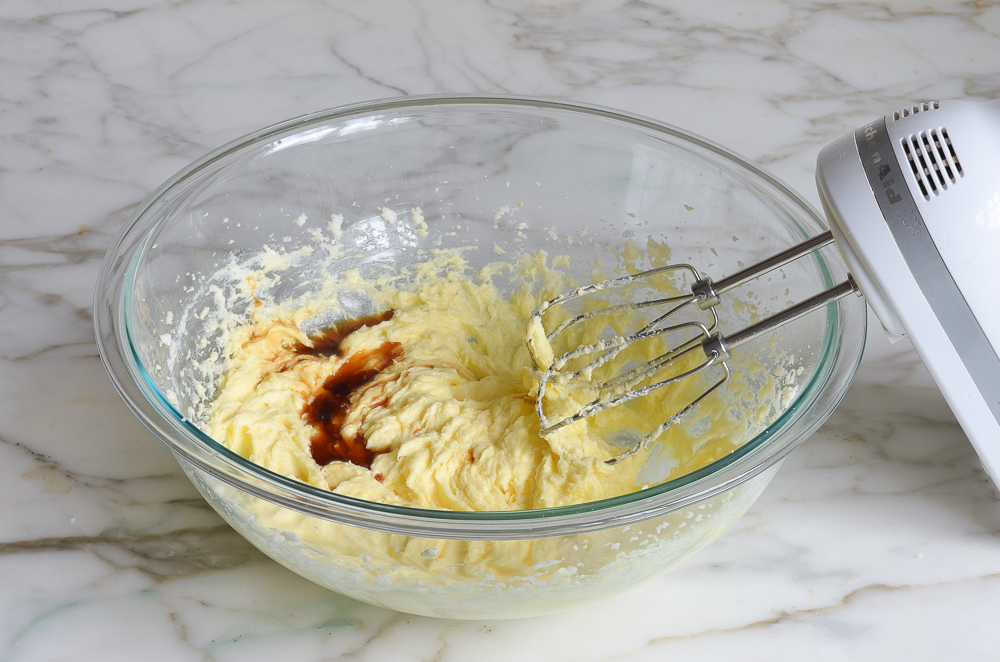 Vanilla added to a bowl of creamed butter and sugar.