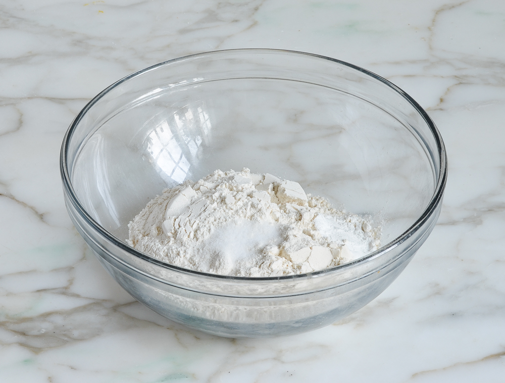 Glass bowl of unmixed dry ingredients.