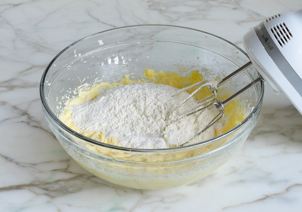 Dry ingredients in a bowl with a creamed mixture.