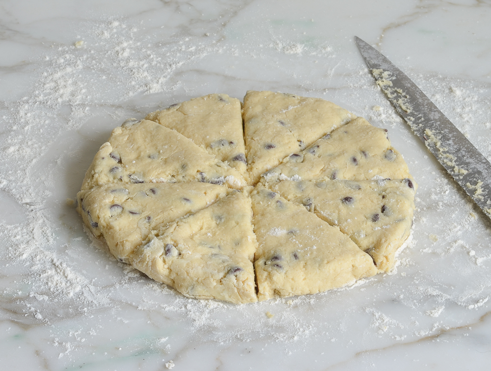 chocolate chip scone dough cut into wedges before baking