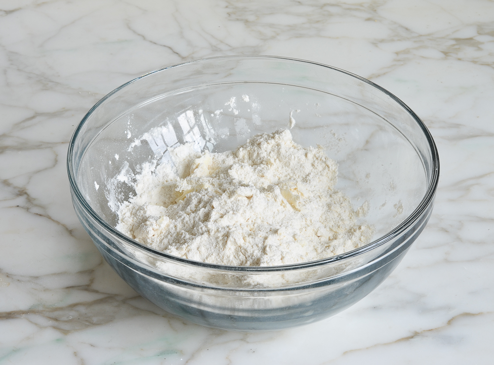 butter mixed with flour in mixing bowl for making chocolate chip scones
