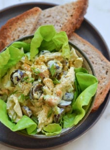 Chicken salad over lettuce in a bowl.