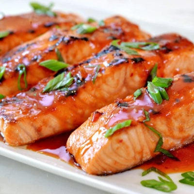 Broiled salmon with Thai sweet chili glaze on a plate.