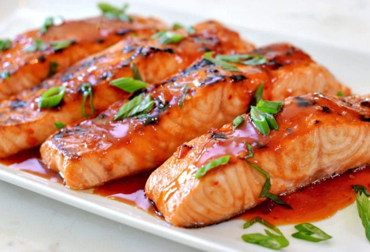 Broiled salmon with Thai sweet chili glaze on a plate.