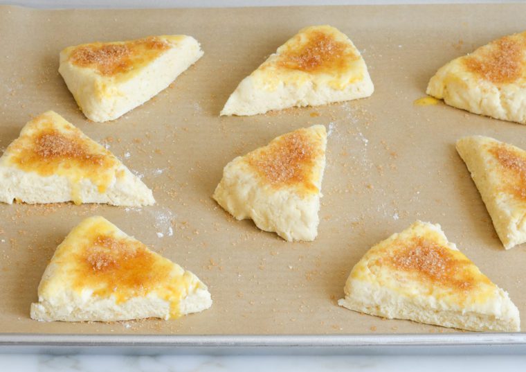 scones on baking sheet with egg and sugar topping