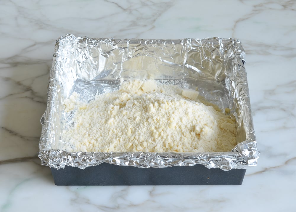 Flour and butter mixture in a foil-lined baking pan.