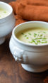 Two white crocks of potato leek soup.