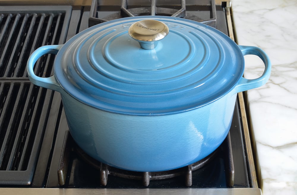 Blue Le Creuset Dutch oven with the lid on.