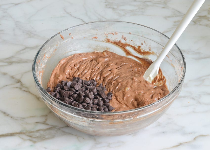 adding chocolate chips to batter