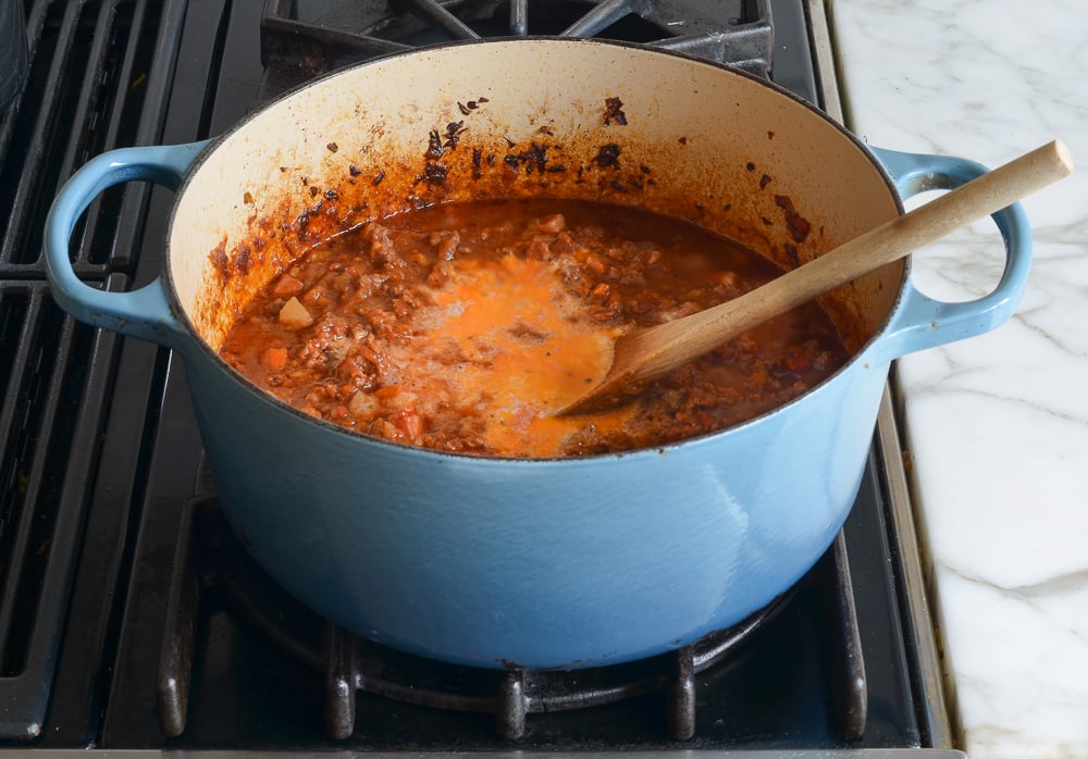 stirring the milk into the bolognese sauce