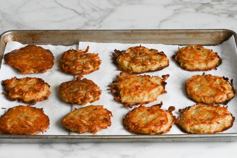 fried latkes on baking lined with paper towels