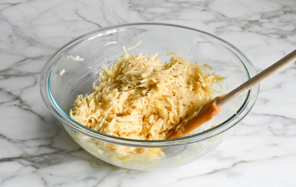 Spatula in a bowl of latke batter.